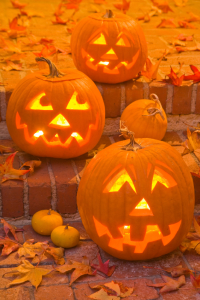 Halloween Jack-O-Lanterns are lit at night