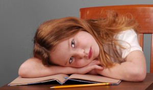 Girl Laying Down Head on Desk