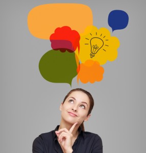 Business woman looking up on idea bulb in color bright bubble on grey background