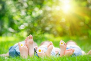 Family lying on grass outdoors in spring park