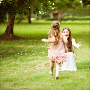 mother and daughter walking in the park, happy at sunset in Bangkok, Thailand.