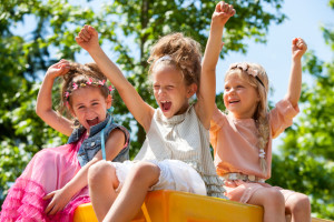 Happy children raising hands and shouting.